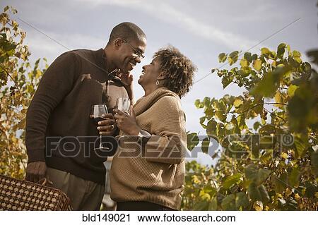 Black couple drinking wine in vineyard View Large Photo Image Stock Image - Black couple drinking wine in vineyard. Fotosearch