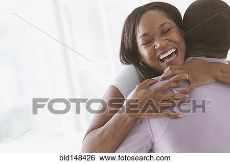 Stock Photograph - Black couple hugging. Fotosearch