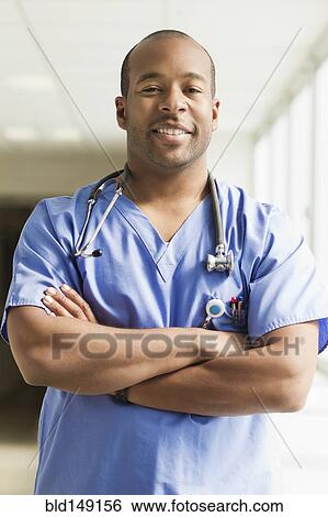 Stock Photograph - Black doctor standing with arms crossed. Fotosearch