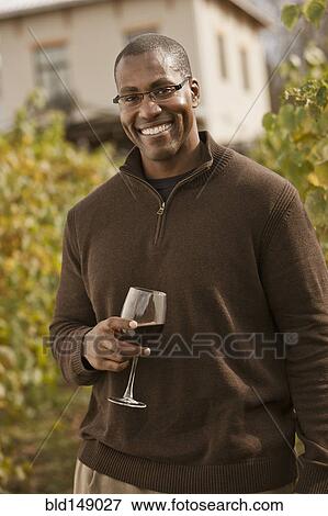 Black man drinking wine in vineyard View Large Photo Image Stock Photo - Black man drinking wine in vineyard. Fotosearch