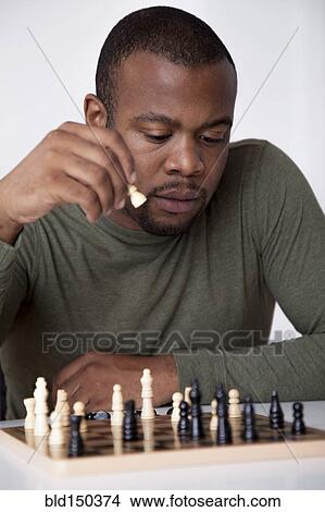 Black man playing chess View Large Photo Image Picture - Black man playing chess. Fotosearch