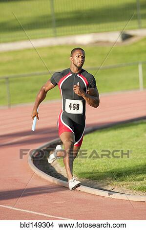 Picture - Black runner carrying baton in relay race. Fotosearch