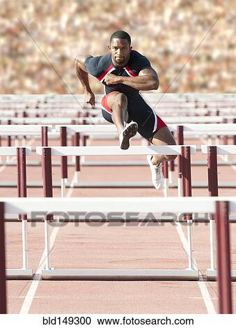 Black runner jumping hurdles in track race View Large Photo Image Stock Image - Black runner jumping hurdles in track race. Fotosearch
