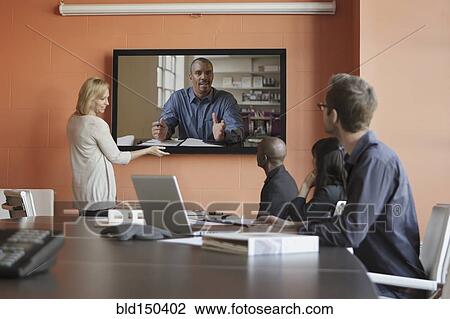 Business people having teleconference in meeting View Large Photo Image Stock Image - Business people having teleconference in meeting. Fotosearch