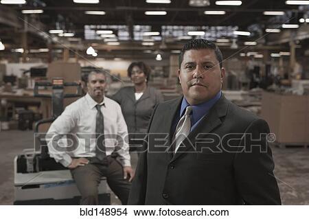 Business people standing in warehouse View Large Photo Image Picture - Business people standing in warehouse. Fotosearch