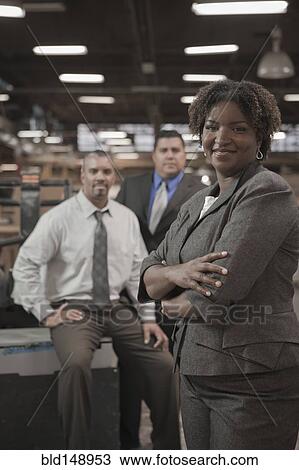 Business people standing in warehouse View Large Photo Image Stock Image - Business people standing in warehouse. Fotosearch
