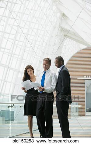 Business people working together in corridor View Large Photo Image Stock Photo - Business people working together in corridor. Fotosearch