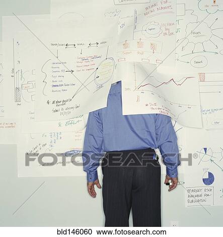 Businessman hiding under drawings on office wall View Large Photo Image Stock Image - Businessman hiding under drawings on office wall. Fotosearch