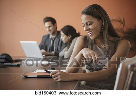 Businesswoman using tablet computer at desk View Large Photo Image Stock Image - Businesswoman using tablet computer at desk. Fotosearch