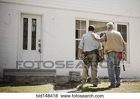 Stock Photo - Carpenters walking toward house. Fotosearch
