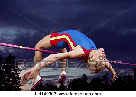Caucasian athlete jumping over bar View Large Photo Image Stock Photo - Caucasian athlete jumping over bar. Fotosearch