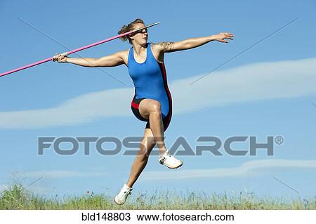 Stock Image - Caucasian athlete throwing javelin. Fotosearch