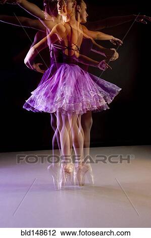Stock Image - Caucasian ballerina dancing on stage. Fotosearch