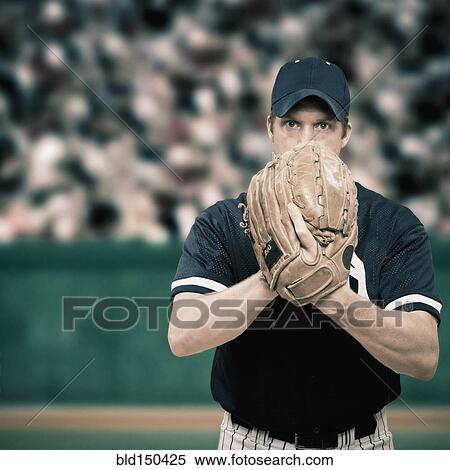 Stock Photography - Caucasian baseball player holding glove. Fotosearch