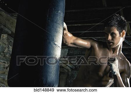 Caucasian boxer training and hitting punching bag View Large Photo Image Stock Photo - Caucasian boxer training and hitting punching bag. Fotosearch