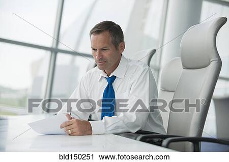 Stock Image - Caucasian businessman working in conference room. Fotosearch