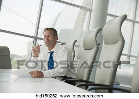 Caucasian businessman working in conference room View Large Photo Image Stock Image - Caucasian businessman working in conference room. Fotosearch