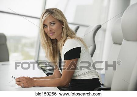 Caucasian businesswoman sitting in conference room View Large Photo Image Stock Photograph - Caucasian businesswoman sitting in conference room. Fotosearch