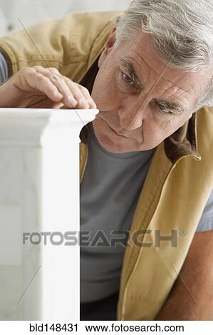 Caucasian carpenter looking at wood detail View Large Photo Image Stock Image - Caucasian carpenter looking at wood detail. Fotosearch