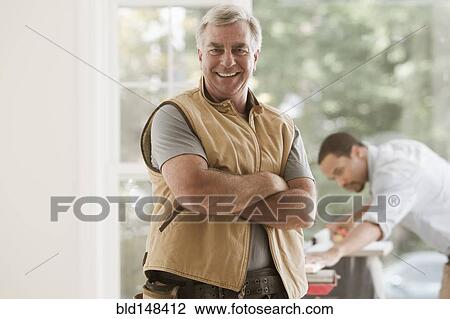 Caucasian carpenter standing with arms crossed View Large Photo Image Stock Image - Caucasian carpenter standing with arms crossed. Fotosearch