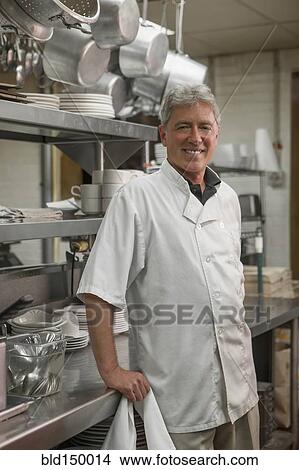Caucasian chef standing in commercial kitchen View Large Photo Image Picture - Caucasian chef standing in commercial kitchen. Fotosearch