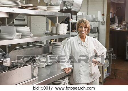 Caucasian chef standing in commercial kitchen View Large Photo Image Stock Photo - Caucasian chef standing in commercial kitchen. Fotosearch