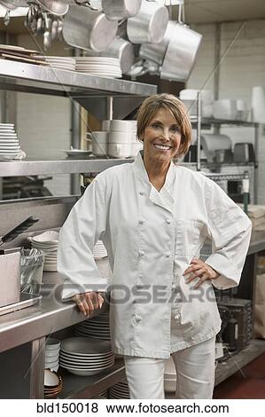 Caucasian chef standing in commercial kitchen View Large Photo Image Stock Photo - Caucasian chef standing in commercial kitchen. Fotosearch