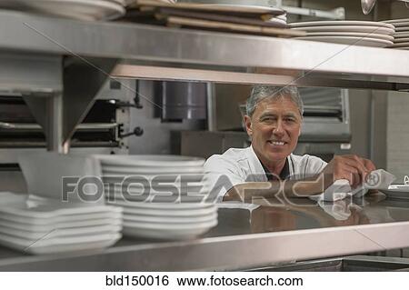 Caucasian chef standing in commercial kitchen View Large Photo Image Stock Photograph - Caucasian chef standing in commercial kitchen. Fotosearch
