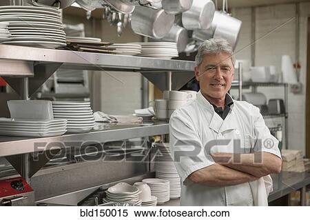 Caucasian chef standing in commercial kitchen View Large Photo Image Stock Photography - Caucasian chef standing in commercial kitchen. Fotosearch