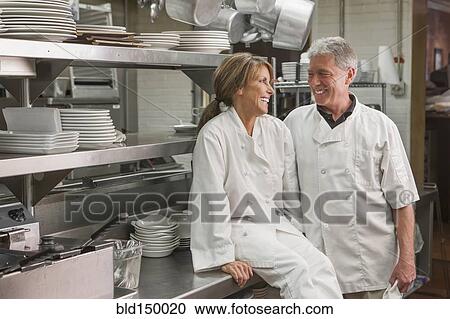 Caucasian chefs in commercial kitchen View Large Photo Image Stock Image - Caucasian chefs in commercial kitchen. Fotosearch