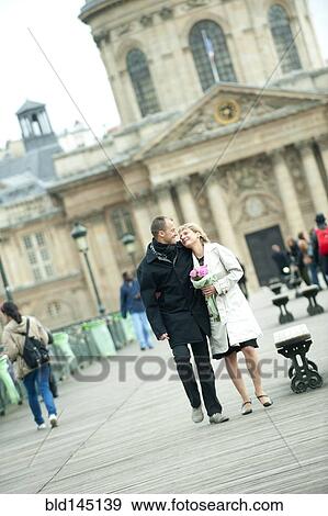 Caucasian couple walking in city plaza View Large Photo Image Stock Photo - Caucasian couple walking in city plaza. Fotosearch