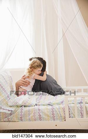 Caucasian father hugging daughter in bed View Large Photo Image Picture - Caucasian father hugging daughter in bed. Fotosearch