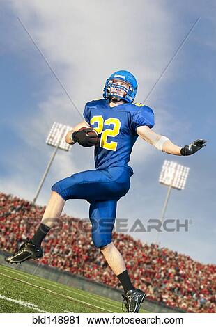 Caucasian football player running with ball View Large Photo Image Stock Image - Caucasian football player running with ball. Fotosearch