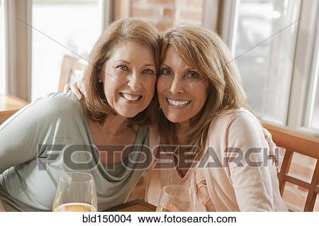 Caucasian friends drinking wine in restaurant View Large Photo Image Picture - Caucasian friends drinking wine in restaurant. Fotosearch