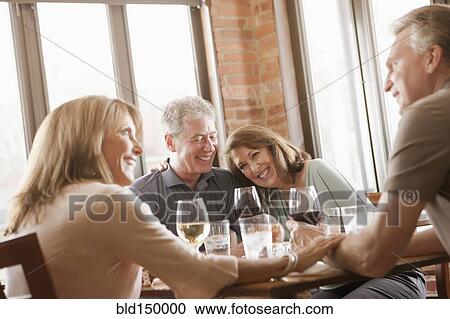 Caucasian friends drinking wine in restaurant View Large Photo Image Stock Image - Caucasian friends drinking wine in restaurant. Fotosearch
