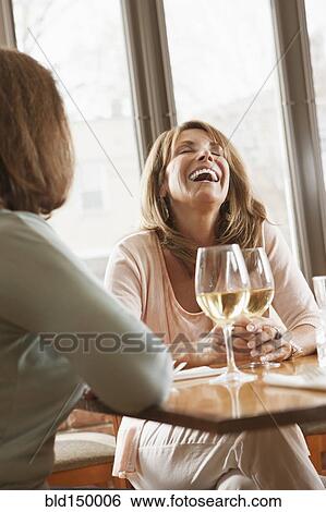 Caucasian friends drinking wine in restaurant View Large Photo Image Stock Photograph - Caucasian friends drinking wine in restaurant. Fotosearch