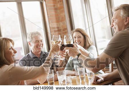 Caucasian friends toasting with wine View Large Photo Image Stock Photo - Caucasian friends toasting with wine. Fotosearch