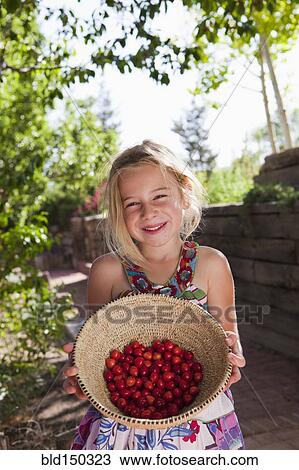 Caucasian girl holding basket of cherries View Large Photo Image Stock Image - Caucasian girl holding basket of cherries. Fotosearch