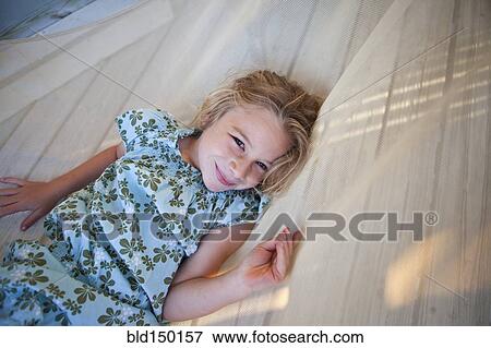 Caucasian girl laying in hammock View Large Photo Image Stock Photo - Caucasian girl laying in hammock. Fotosearch