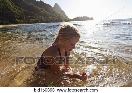 Caucasian girl playing in ocean View Large Photo Image Stock Image - Caucasian girl playing in ocean. Fotosearch