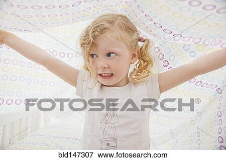 Caucasian girl playing underneath bed sheet View Large Photo Image Stock Photo - Caucasian girl playing underneath bed sheet. Fotosearch