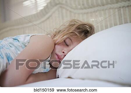 Stock Photo - Caucasian girl sleeping in bed. Fotosearch