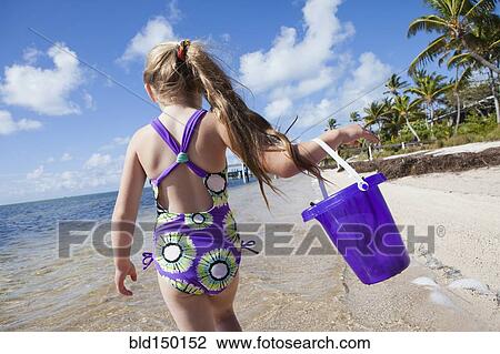 Caucasian girl walking on beach View Large Photo Image Stock Image - Caucasian girl walking on beach. Fotosearch