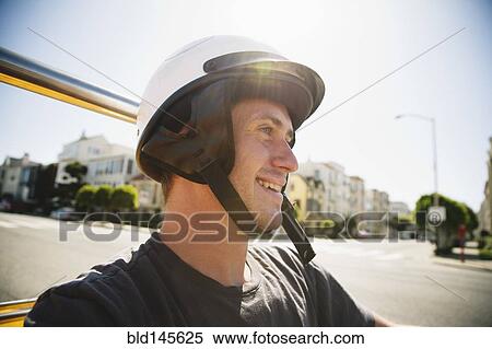 Stock Photography - Caucasian man in helmet driving go-cart. Fotosearch