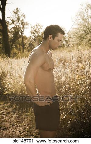 Stock Image - Caucasian man relaxing after exercise. Fotosearch