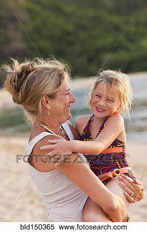 Caucasian mother and daughter enjoying the beach View Large Photo Image Stock Photography - Caucasian mother and daughter enjoying the beach. Fotosearch