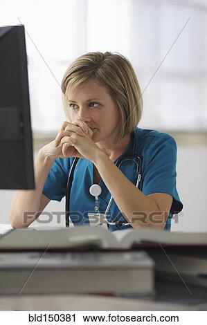Caucasian surgeon reading books and using computer View Large Photo Image Stock Image - Caucasian surgeon reading books and using computer. Fotosearch