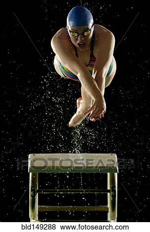 Caucasian swimmer diving off starting block View Large Photo Image Stock Photo - Caucasian swimmer diving off starting block. Fotosearch