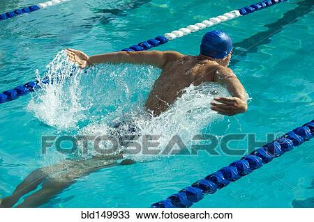 Stock Image - Caucasian swimmer in swimming lane. Fotosearch