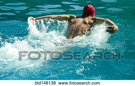 Stock Photo - Caucasian swimmer training in swimming pool. Fotosearch